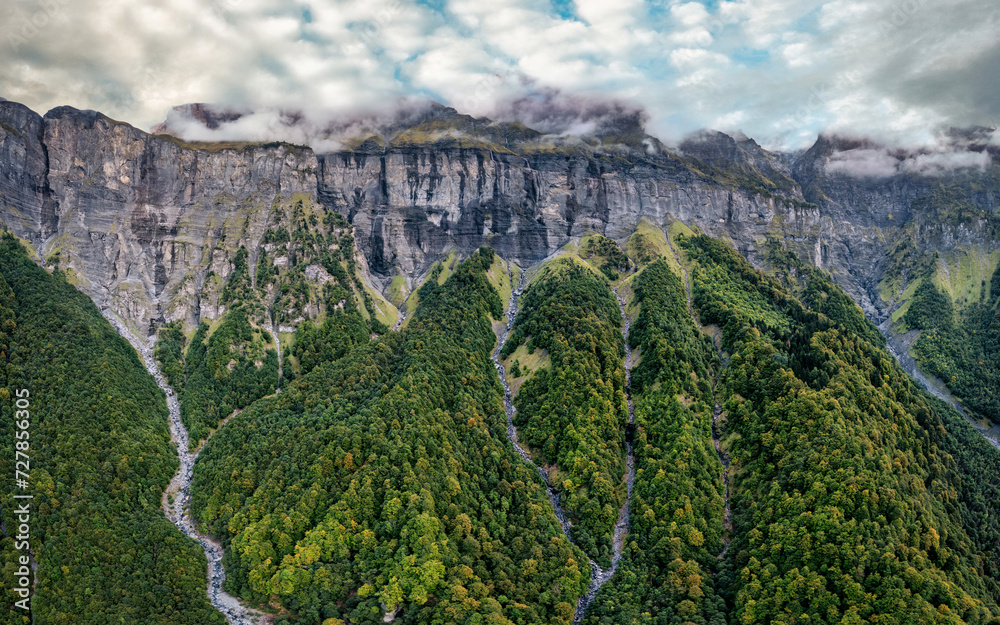 Giffre valley of mountain range with cascade and foggy in French Alps at Sixt Fer a Cheval, France