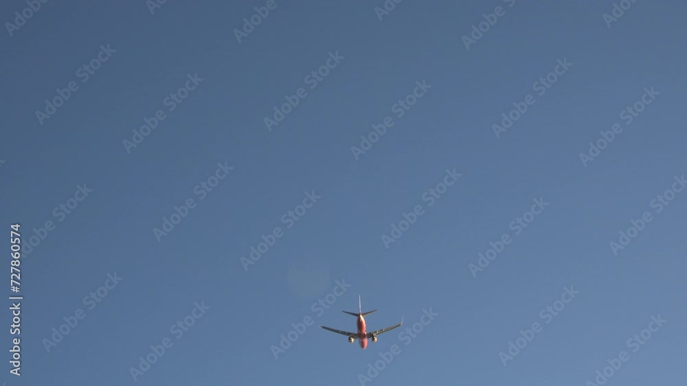 Orange plane departure take off flight on blue sky Orange plane departure take off flight on blue sky