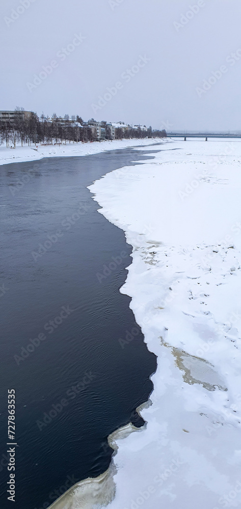 frozen river in rovaniemi finland in winter with ice and snow