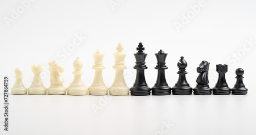 White and black chess include king queen horse ship and pawn on white background.