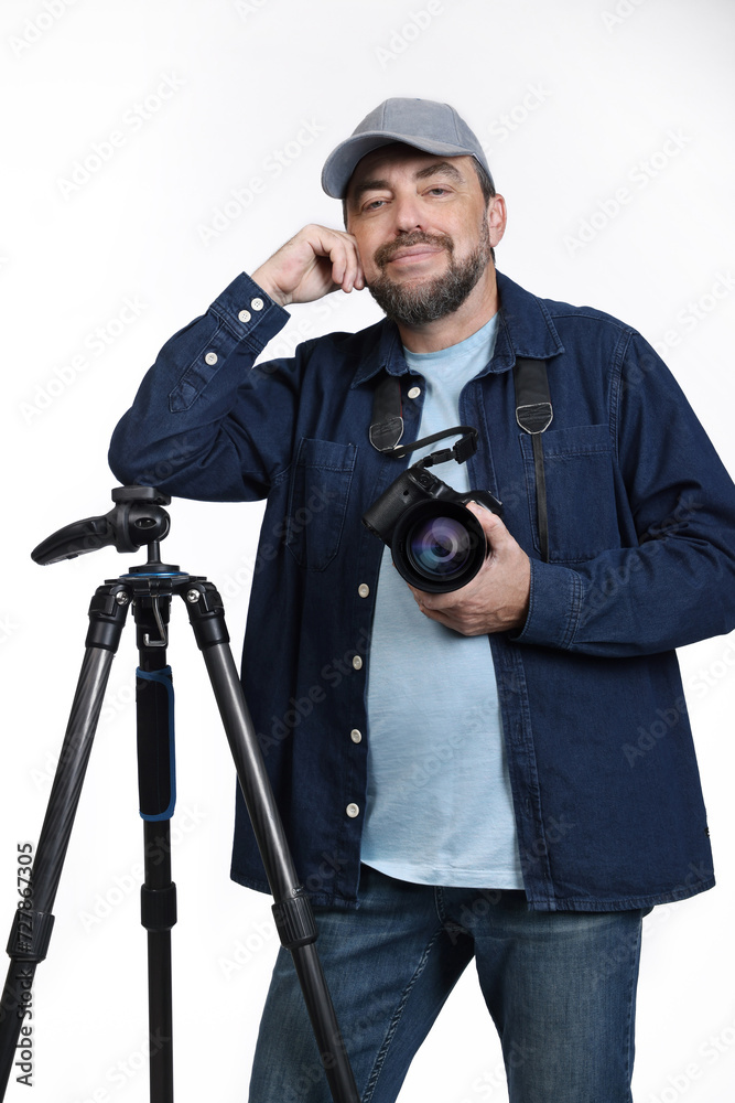 Male photographer posing with modern digital SLR camera and tripod isolated on white background