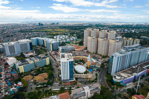 Taguig, Metro Manila, Philippines - Feb 03, 2024: Aerial of Venice Grand Mall and Mckinley Hill, an upscale district near BGC. The rest of southern NCR in the distance. photo