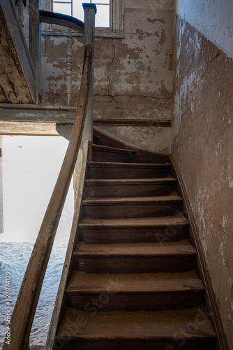 Old wooden staircase in an abandoned building in an old desert town