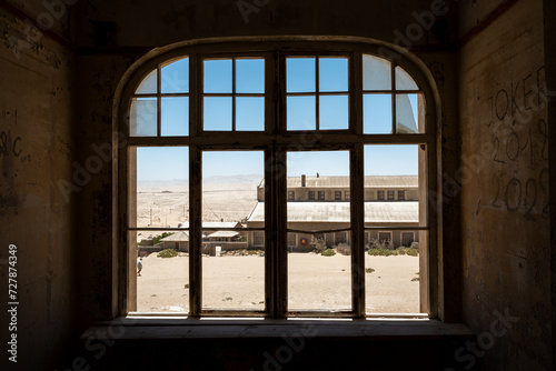Aged  dilapidated room with a big window in an old desert town