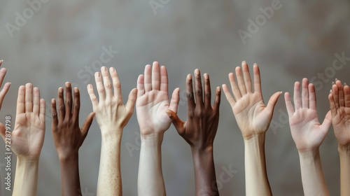 overhead view of multiple hands of diverse skin tones coming together in the center, symbolizing unity and teamwork