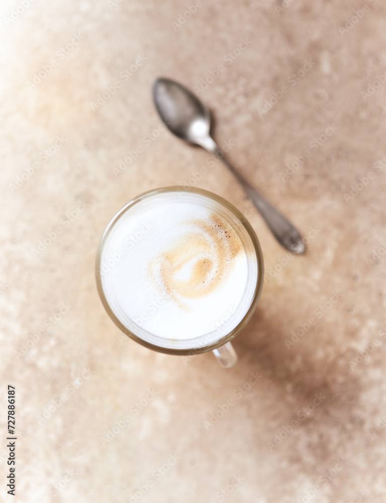 Coffee with milk on bright stone background. Close up. Coffee with milk on bright stone background. Close up.