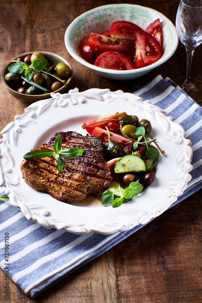 Grilled pork steak with fresh salad. Close up. Grilled pork steak with fresh salad. Close up.