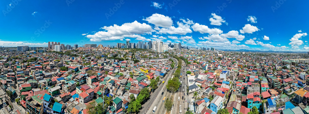 Taguig, Metro Manila, Philippines - Panoramic Aerial of C5 road, poorer areas of Taguig, upscale Mckinley Hill, and BGC business district.