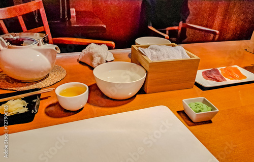 Preparing to Make Sushi with Traditional Japanese White Tea over bamboo table photo