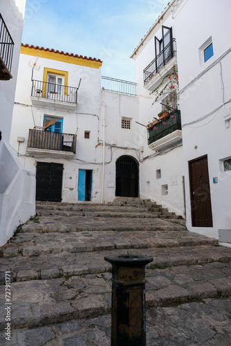 Fototapeta Naklejka Na Ścianę i Meble -  Romantic backstreet, side street and alleys in historic old town of Ibiza Stadt, Balearic Island with historic Mediterranean style architecture facades, a landmark sightseeing tourist spot in downtown