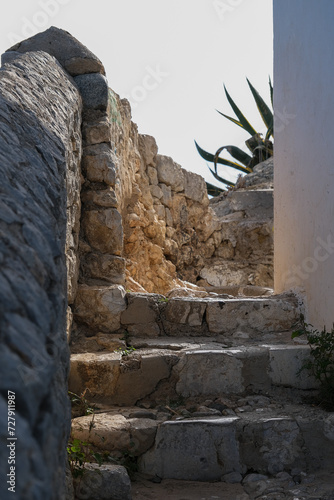 Romantic backstreet, side street and alleys in historic old town of Ibiza Stadt, Balearic Island with historic Mediterranean style architecture facades, a landmark sightseeing tourist spot in downtown photo