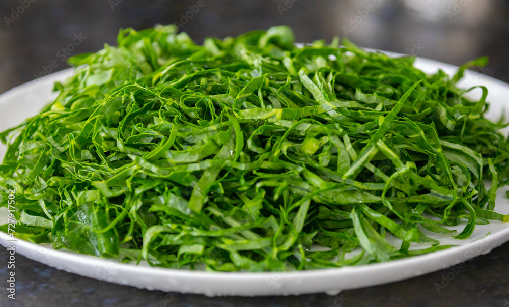 Kale leaves chopped and sliced into thin strips Kale leaves chopped and sliced into thin strips