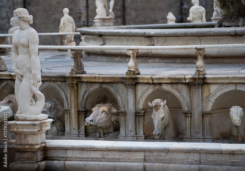 ancient Statues in piazza square in palermo sicily italy animal sculptures looking at female figure statue at water fountain in Palermo  on holiday travel destination background backdrop horizontal 