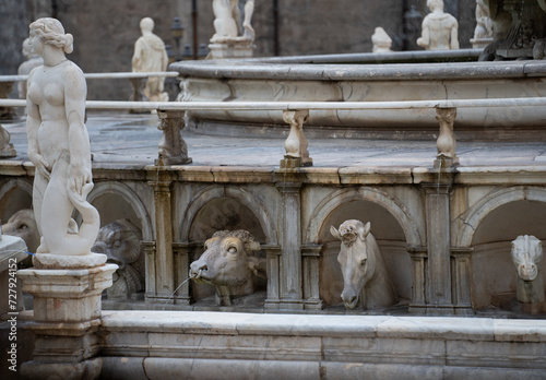 ancient Statues in piazza square in palermo sicily italy animal sculptures looking at female figure statue at water fountain in Palermo  on holiday travel destination background backdrop horizontal  photo