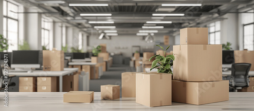 Big open plan office space with office furniture Packing cardboard mockup boxes and cartons at the foreground. Moving in or out and relocation services. Closing down or opening business. Delivery photo