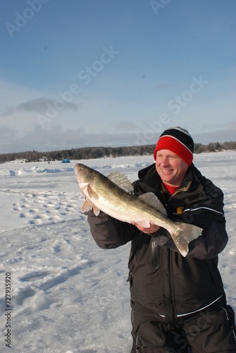 Ice angler with a walleye