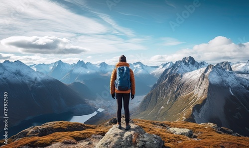Adventurer Standing on Mountain Top With Backpack © uhdenis