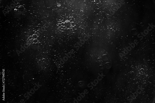 Air bubbles in the water background.Abstract oxygen bubbles in the sea.Water bubbles isolate on black background.Black and white tone style.