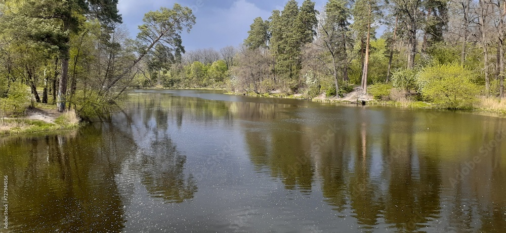 Beautiful landscape of river and forest on shores in sunny summer day Beautiful landscape of river and forest on shores in sunny summer day