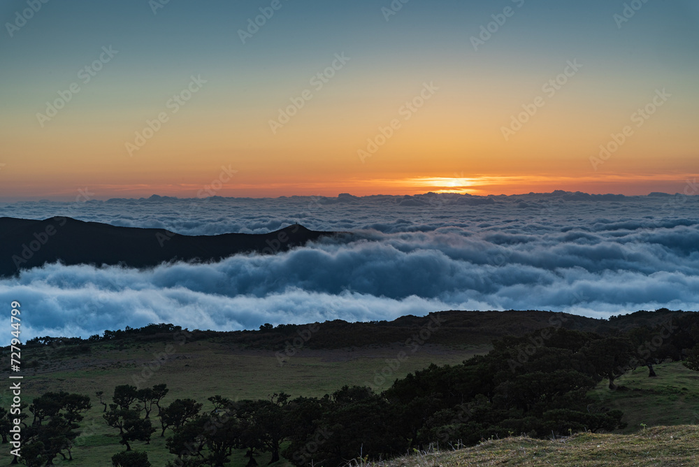 Sunset with clouds and orange clear ska above from Fanal in Madeira