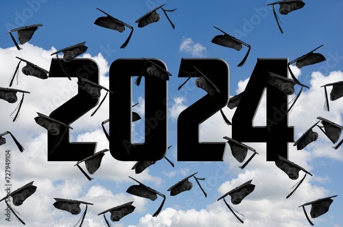 Airborne black graduation caps for 2024 in sky with white clouds 