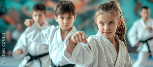 Dynamic Karate Girl and Boy Display Their Skills in Black Belts photo