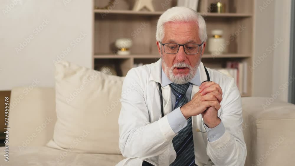 Sad tired mature senior male doctor in medical uniform in hospital or doctor office. Unhappy General Practitioner GP therapist professional healthcare expert in clinic. Healthcare concept Sad tired mature senior male doctor in medical uniform in hospital or doctor office. Unhappy General Practitioner GP therapist professional healthcare expert in clinic. Healthcare concept
