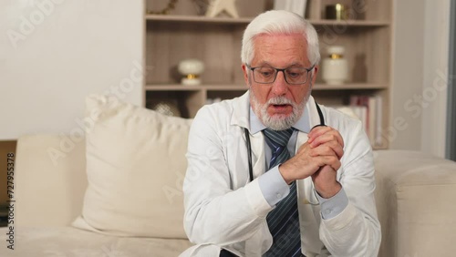 Wallpaper Mural Sad tired mature senior male doctor in medical uniform in hospital or doctor office. Unhappy General Practitioner GP therapist professional healthcare expert in clinic. Healthcare concept Torontodigital.ca