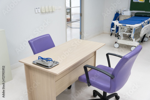 Interior of empty physician office with desk and chairs.Modern and bright doctor office with copy space.Medical tools at doctor working table.