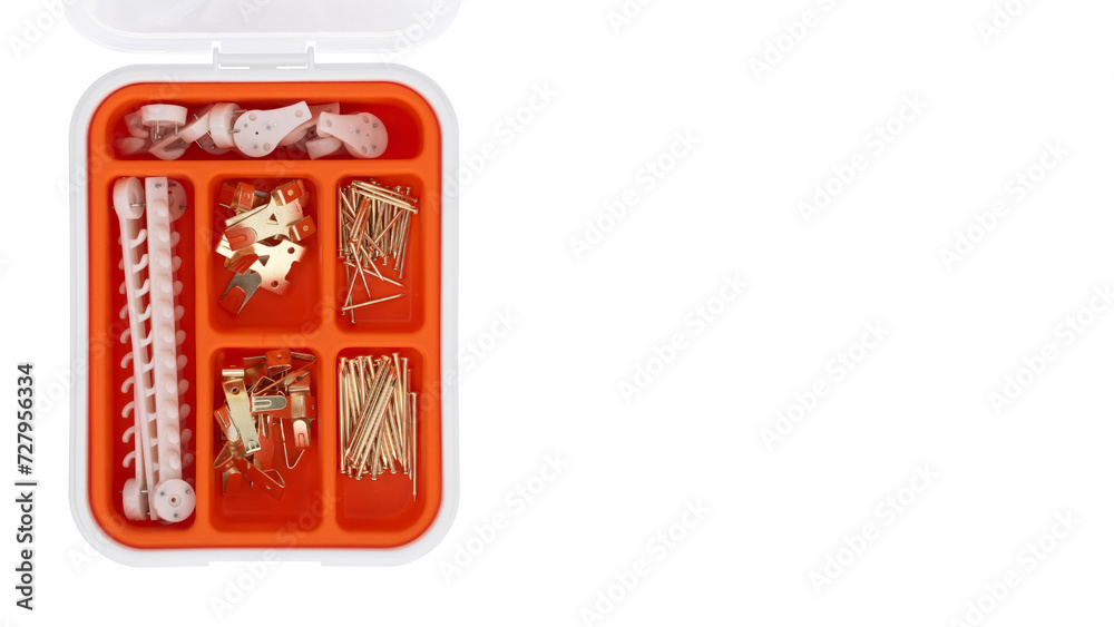 Top view closeup of orange tool case with nails and accessories on white copy-space background. Top view closeup of orange tool case with nails and accessories on white copy-space background.
