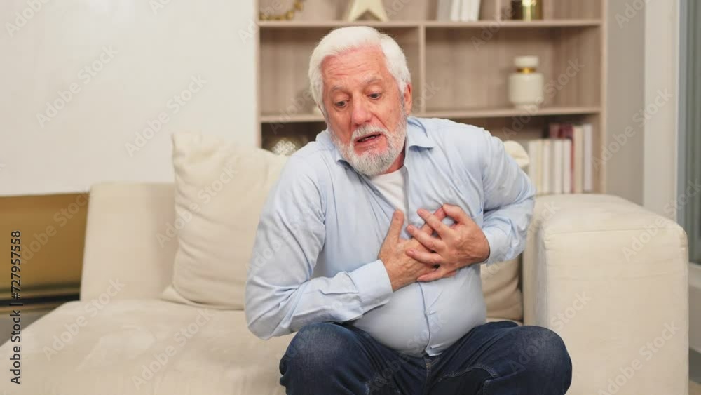 Pain on heart, heart attack. Unhappy middle aged senior man suffering from chest pain heart attack problems with health at home. Mature old senior grandfather touching chest experiencing infarction Pain on heart, heart attack. Unhappy middle aged senior man suffering from chest pain heart attack problems with health at home. Mature old senior grandfather touching chest experiencing infarction