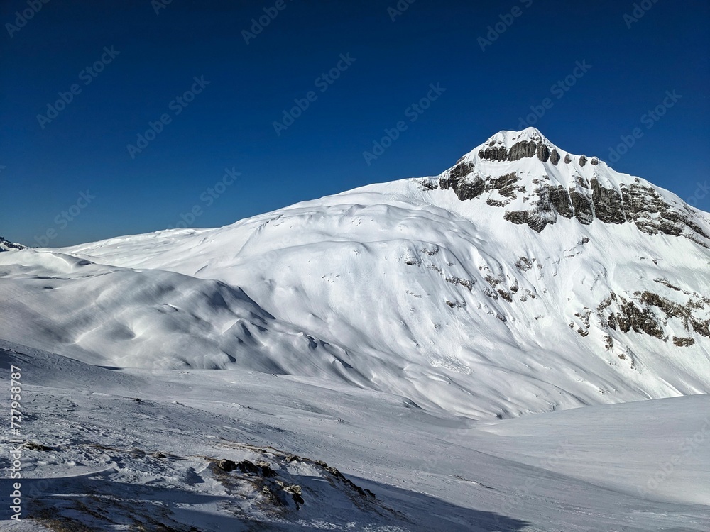 Obraz premium Ski touring in Glarnerland and Schwyz. Ski mountaineering on the Pfannenstock. Skitour above Braunwald Glarus. Skimo in winter country. High quality photo.