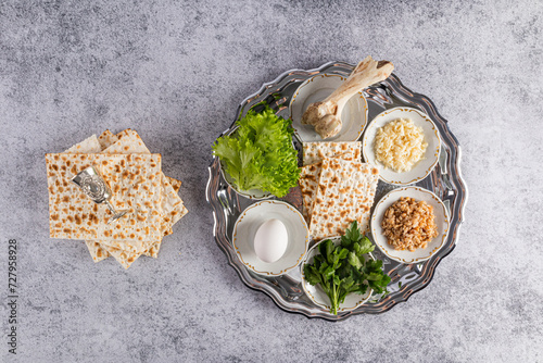 Top view of a silver rich seder tray with traditional treats for the Jewish Passover holiday. Marble background. Passover concept.