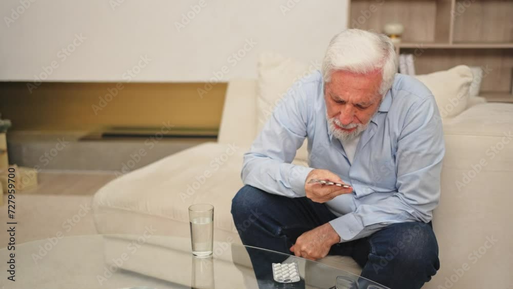 Middle aged senior man with medical pill and glass of water. Mature old senior grandfather taking medication cure pills vitamin. Age prescription medicine healthcare therapy concept Middle aged senior man with medical pill and glass of water. Mature old senior grandfather taking medication cure pills vitamin. Age prescription medicine healthcare therapy concept