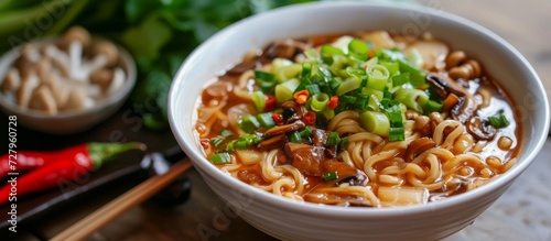 Delicious Traditional Chinese Cuisine: Savory Mushroom Soup and Flavorful Noodles photo
