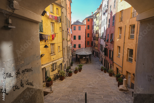 Fototapeta Naklejka Na Ścianę i Meble -  Romantic backstreet, side street or alley in historic old town of Genoa, Italy with historic Mediterranean style architecture facades, a landmark sightseeing tourist spot in downtown