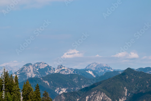 Panoramic view from lift station Monte Lussari in untamed Julian Alps in Camporosso  Friuli Venezia Giulia  Italy. Looking at majestic mountain peaks of Carnic Alps  border to Austria. Monte Scinauz