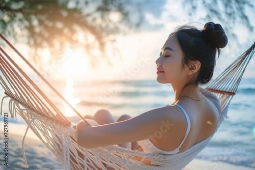 Summer travel vacation concept, Happy traveler asian woman with white bikini relax in hammock on beach