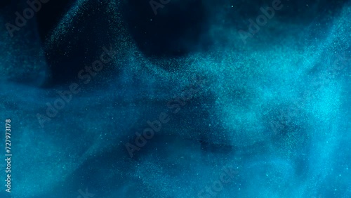 White luminous particles shimmer in blue liquid. Abstract digital particle wave and light abstract background. Floating particals in ocean.  photo