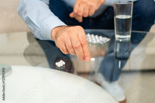 Hands with pills. Senior man hands with medical pill and glass of water. Mature old senior grandfather taking medication cure pills vitamin. Age prescription medicine healthcare therapy concept