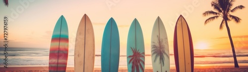 Surfboards on a sandy beach with palm trees in the background. Surfboards on the beach. Vacation Concept with Copy Space.