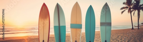 Surfboards on the beach at sunset. Concept of summer sport. © John Martin