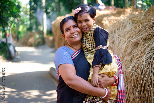 Smiling portrait of a south asian hindu religious mother and daughter , family togetherness concept  photo