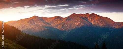Mountain range in the morning rays of the sun. Carpathian National Park, Ukraine.