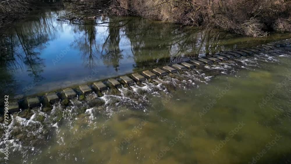 Aerial crossing over concrete steps in river bed in spring Aerial crossing over concrete steps in river bed in spring