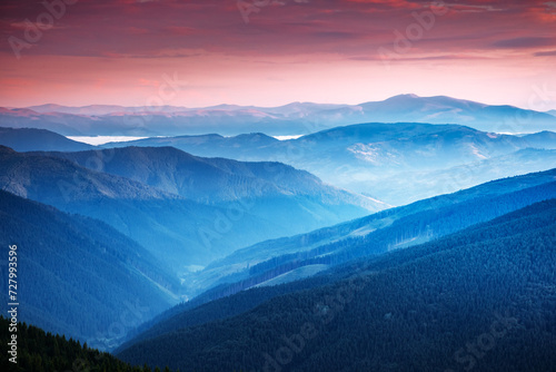 Splendid view of distant mountain ranges in morning light © Leonid Tit