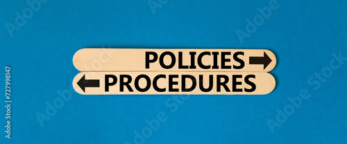 Procedures and policies symbol. Concept word Procedures Policies on beautiful wooden stick. Beautiful blue table blue background. Business procedures and policies concept. Copy space photo