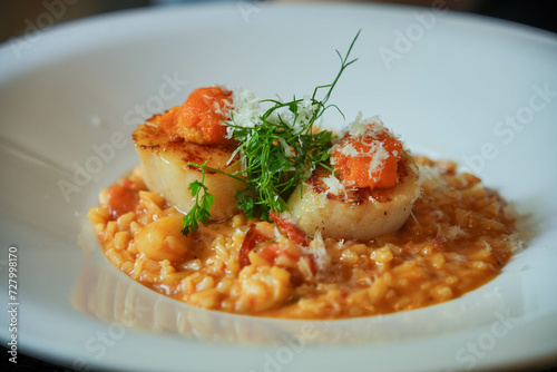 A delectable risotto with succulent scallops and fresh shrimp, a must-try for seafood lovers seeking a delicious feast.