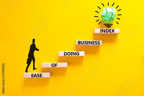 Ease of doing business index symbol. Concept words Ease of doing business index on wooden blocks. Beautiful yellow table yellow background. Business, ease of doing business index concept. Copy space.