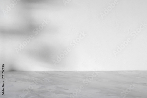 Neutral gray marble empty podium table and textured white concrete wall background with abstract natural aesthetic sunlight shadows, minimal mockup for beauty product placement or business branding © Viktoriia
